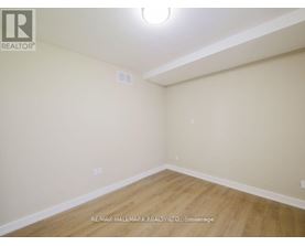 A room with a wooden floor and white walls.
