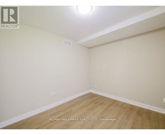 A room with a wooden floor and white walls.