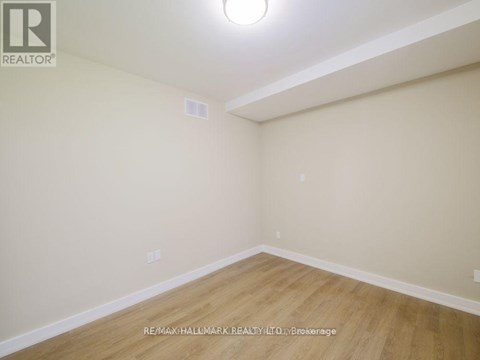 A room with a wooden floor and white walls.