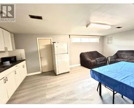 A living room with a couch, chair, and table.