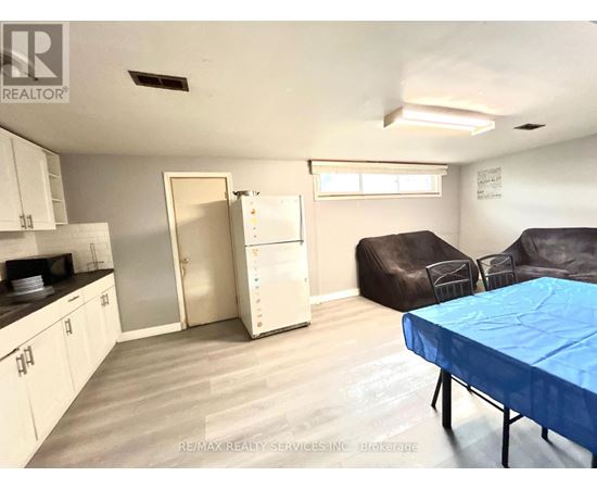 A living room with a couch, chair, and table.