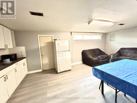A living room with a couch, chair, and table.