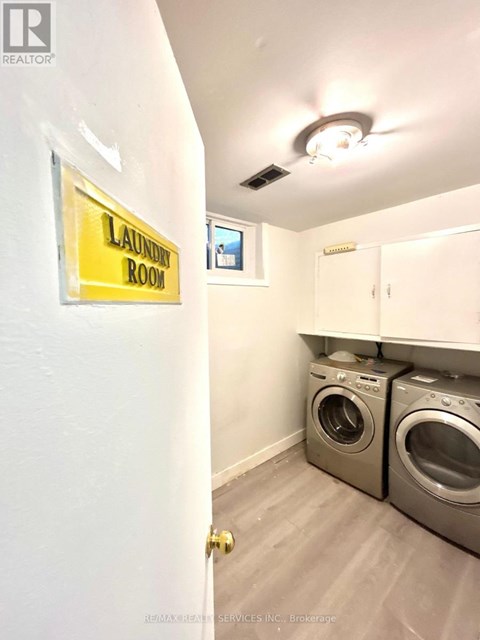 Laundry room with washers and dryers.