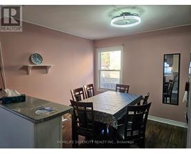 A dining room with a table set for four.