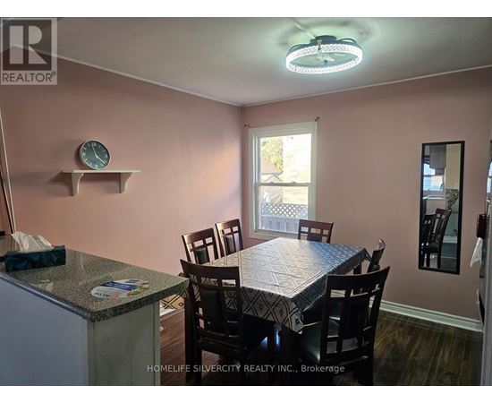 A dining room with a table set for four.