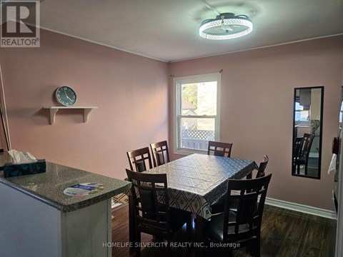 A dining room with a table set for four.