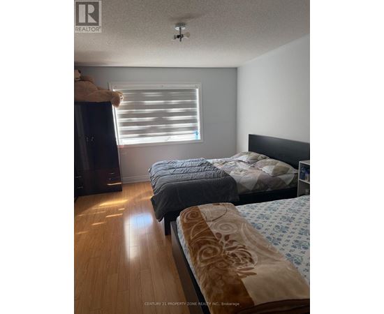 A bedroom with two beds and a dresser.