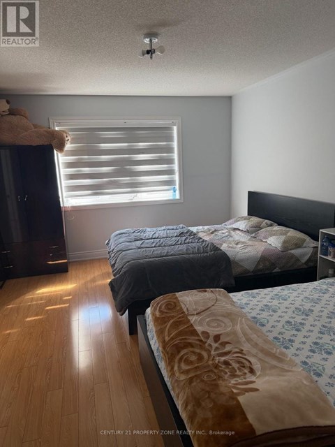 A bedroom with two beds and a dresser.