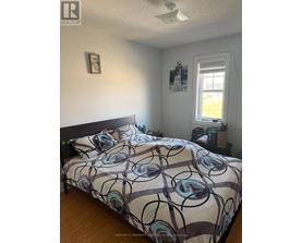 A bedroom with a bed and a window.