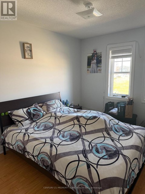 A bedroom with a bed and a window.