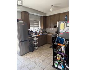A kitchen with a refrigerator and a pantry.