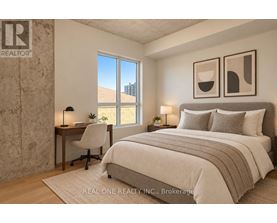 A bedroom with a large bed, a desk with a chair, and two framed pictures on the wall.