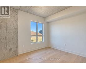 A room with a large window and a view of a building outside.