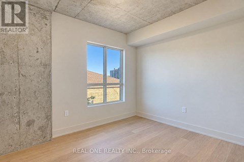 A room with a large window and a view of a building outside.