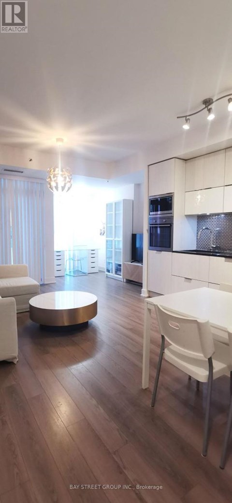 A modern living room with a white sofa and a wooden coffee table.