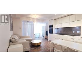 A modern kitchen with white cabinets and a dining area with a white table and chairs.