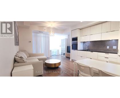 A modern kitchen with white cabinets and a dining area with a white table and chairs.