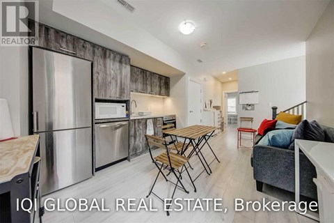 A modern kitchen with a dining table and chairs.