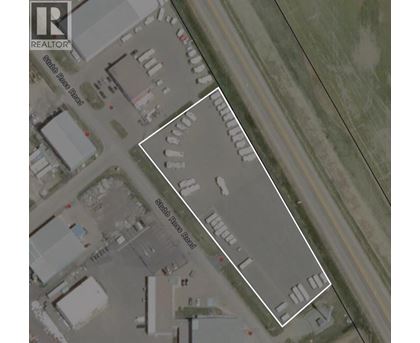 A satellite image of a parking lot with a white line drawn on it.