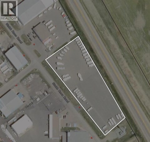 A satellite image of a parking lot with a white line drawn on it.