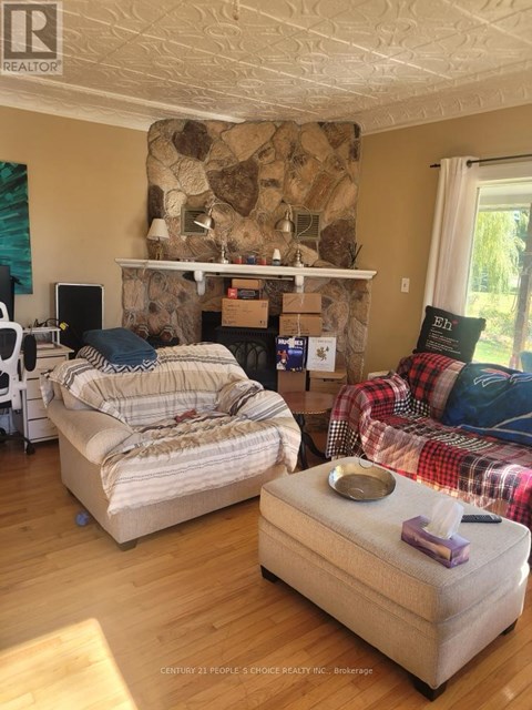 A living room with a stone fireplace and two couches.