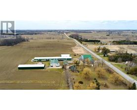 An aerial view of a farm with a sign that reads "Century 21 People 5 Choice Realty Inc. Brokerage".