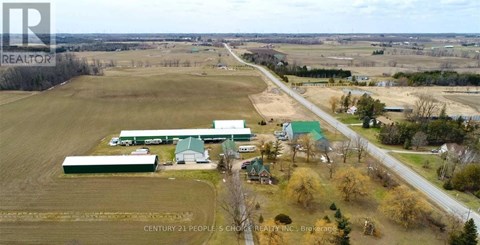 An aerial view of a farm with a sign that reads "Century 21 People 5 Choice Realty Inc. Brokerage".