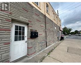 A building with a white door and a mailbox on the side.