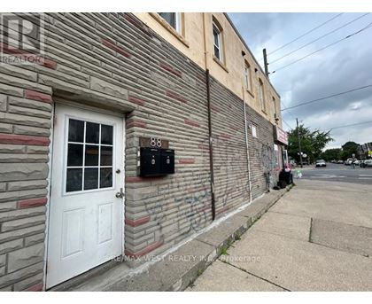 A building with a white door and a mailbox on the side.