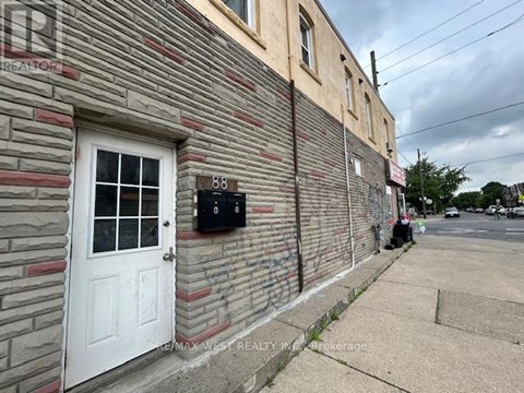 A building with a white door and a mailbox on the side.