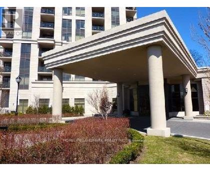 A building with a white facade and a covered walkway.