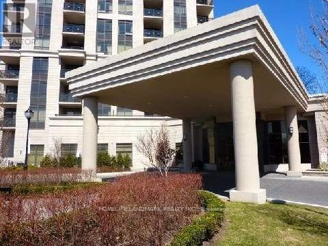 A building with a white facade and a covered walkway.