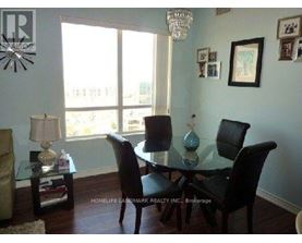 A dining room with a glass table and chairs.