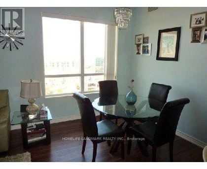 A dining room with a glass table and chairs.