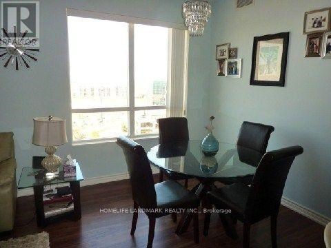 A dining room with a glass table and chairs.