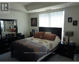 A bedroom with a bed, dresser, and mirror.