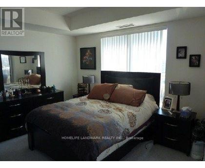 A bedroom with a bed, dresser, and mirror.