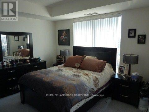 A bedroom with a bed, dresser, and mirror.