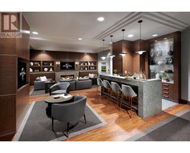 A modern kitchen with a bar area and seating.