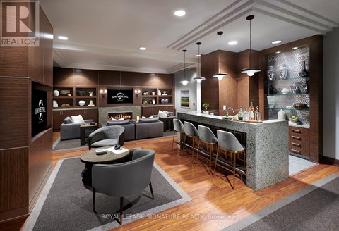A modern kitchen with a bar area and seating.
