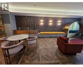 A room with a wooden floor and a bench with a backrest.