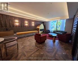 A living room with a wooden floor and a large window.