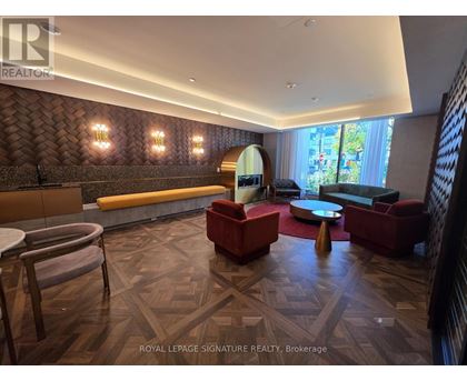 A living room with a wooden floor and a large window.