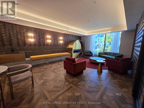 A living room with a wooden floor and a large window.