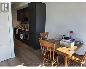A kitchen with a wooden table and chairs.