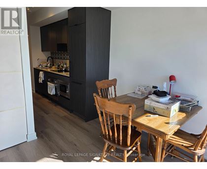 A kitchen with a wooden table and chairs.
