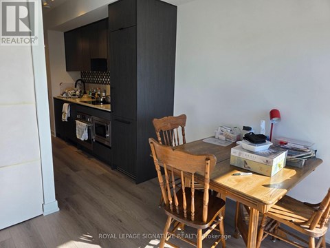 A kitchen with a wooden table and chairs.