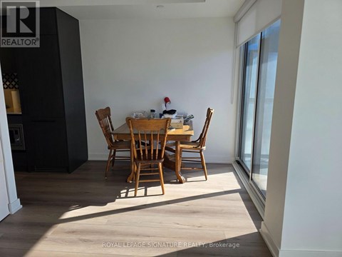 A dining room with a table and chairs.