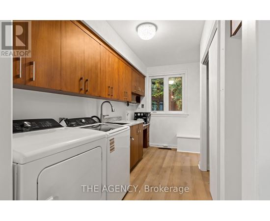 A small kitchen with wooden cabinets and white appliances.