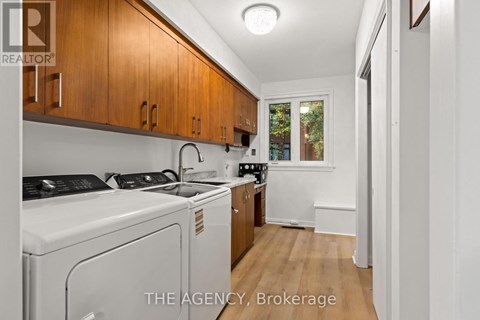 A small kitchen with wooden cabinets and white appliances.